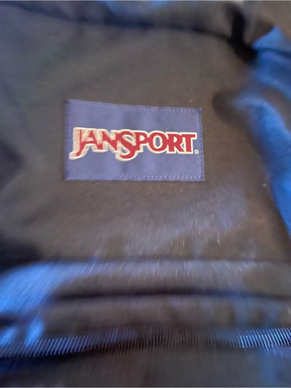 Jansport Black Backpack with Red and White Logo Patch